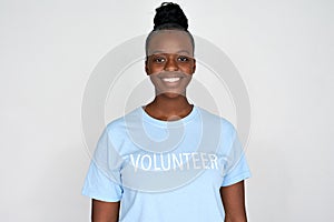 Happy african woman activist wear volunteer tshirt isolated on grey background.