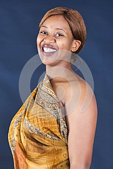 happy african woman with a brownish traditional dress