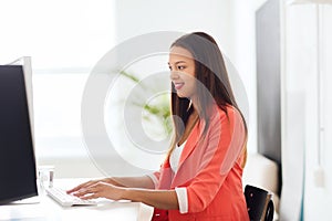 Happy african woman with computer at office