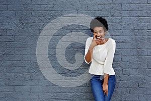 Happy african woman covering her mouth and laughing