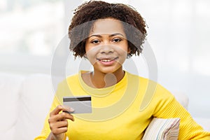 Happy african woman with credit or debit card