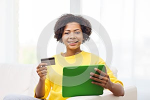 Happy african woman with tablet pc and credit card