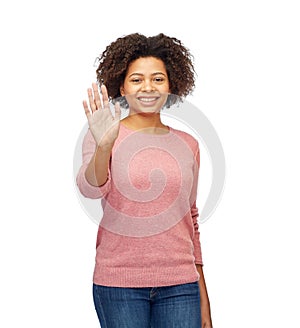 Happy african woman waving hand over white