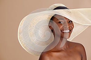 Happy african woman wearing straw hat with a wide brim