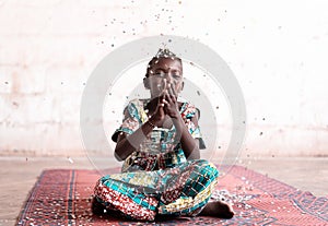 Happy African Young Woman smiling at the camera having fun with confetti party indoor at home