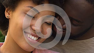 Happy afro american couple embracing and smiling, closeness, spiritual affinity