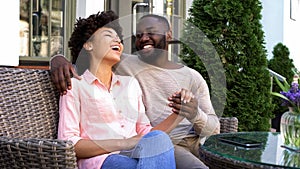 Happy afro-american couple enjoying romantic date, sitting cafe, relations