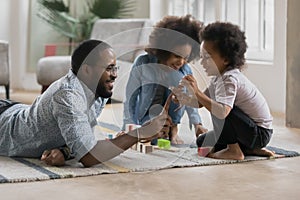 Happy Afro American daddy and cute kids playing with toy