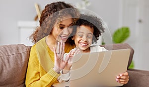 Happy afro american family mother and son having video call with family on laptop while spending time together at home