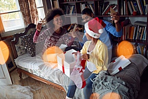 Happy Afro-American family opening Christmas presents