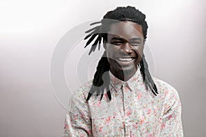 Happy Afro-American man smiling on white studio background. African American male profile portrait