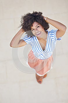 Happy afro american woman holding hands above head