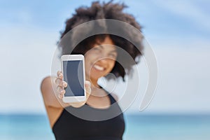 Happy afro american woman holding smartphone