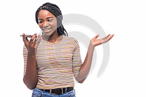 Happy afro american woman talking on the phone and looking away over white background