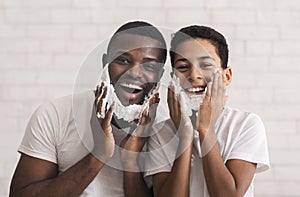 Happy Afro Father And His Son With Shaving Foam On Faces