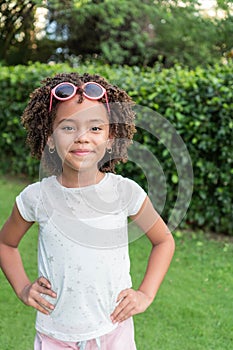 Happy afro girl standing in the park. Casual style