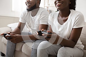 Happy afro guy and girl playing video games with joysticks