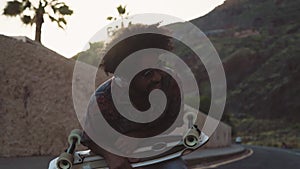 Happy Afro man having fun dancing while listening to music with wireless headphones during summer