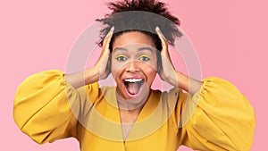 Happy afro woman screaming and grabbing her head