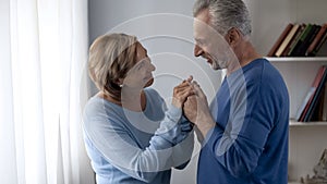 Happy aging couple looking at each other and smiling, trustful relationship