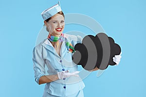 happy air hostess woman on blue showing blank cloud shape board