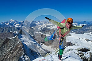 Happy alpine climber on snow mountain ridge