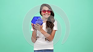 happy amazed child in sunglasses hold present box, amazement