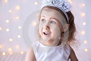 Happy amazed female kid emotion. Suprised child studio portrait. Young girl