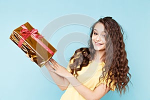 Happy amazed woman with golden present box.