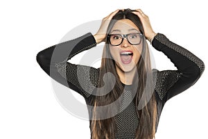 Happy amazed young woman with glasses