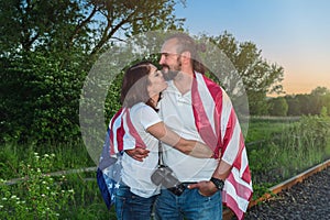 Happy american couple celebrating Memorial day with american flag. Independence day celebration