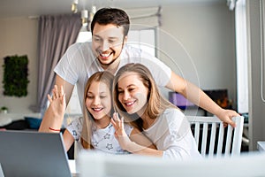 Happy american family having online meeting with relatives. Family in front of laptop monitor.