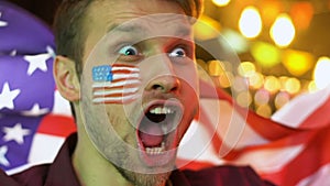 Happy American man waving flag, celebrating national football team victory