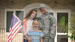 Happy american patriots family looking at camera, social insurance for veterans