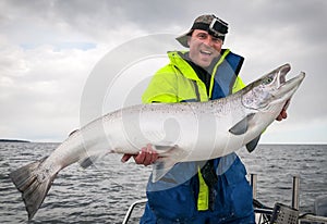 Happy angler with Baltic salmon