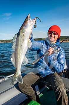 Happy angler holds Zander fish