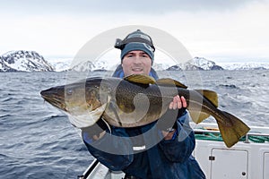 Happy angler with huge cod fish