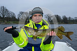 Happy angler with pike