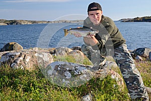 Happy angler with sea trout