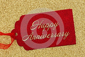 Happy Anniversary greeting red gift tag on gold