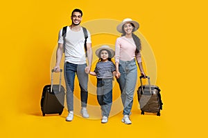 Happy Arab Family Of Three Holding Hands And Walking With Suitcases