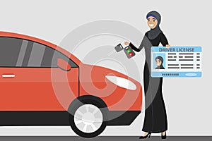Happy Arab Girl or Saudi woman with driver license and car key i