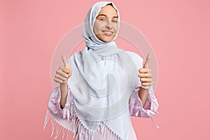 Happy arab woman in hijab. Portrait of smiling girl, posing at studio background