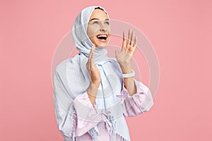 Happy arab woman in hijab. Portrait of smiling girl, posing at studio background