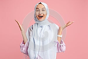 Happy arab woman in hijab. Portrait of smiling girl, posing at studio background