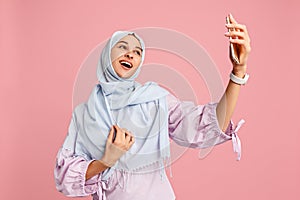 Happy arab woman in hijab. Portrait of smiling girl, posing at studio background