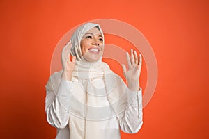 Happy arab woman in hijab. Portrait of smiling girl, posing at studio background