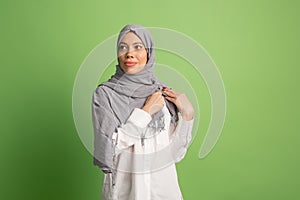 Happy arab woman in hijab. Portrait of smiling girl, posing at studio background