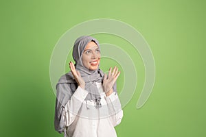 Happy arab woman in hijab. Portrait of smiling girl, posing at studio background