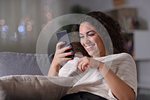 Happy arab woman using smart phone in the night